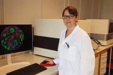 Lina Olsson framför en dator som analyserar celler
