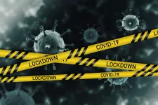 Image of COVID-viruses and yellow tape with the text "lockdown"