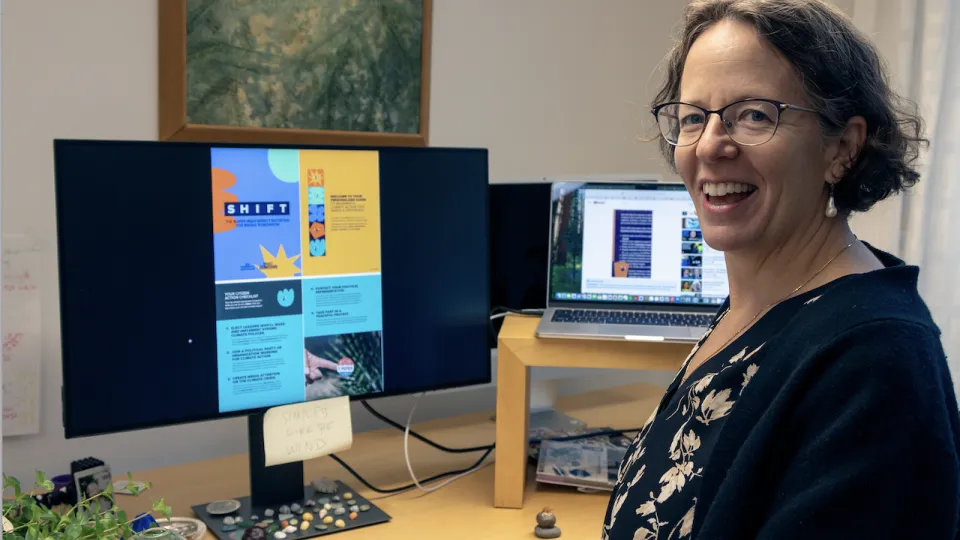 En kvinna, Kimberly Nicholas, som sitter vid en datorskärm som visar guiden SHIFT. Bild: Theo Hagman-Rogowski.