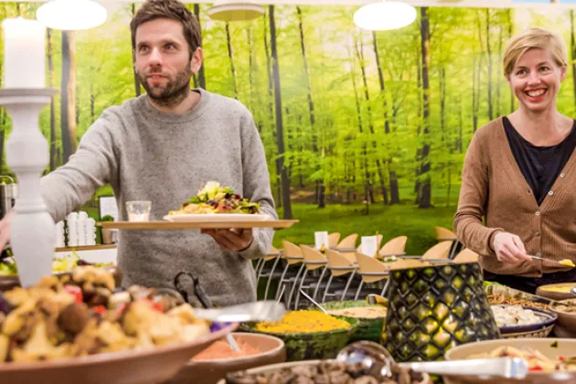 Man och kvinna tar mat i restaurang