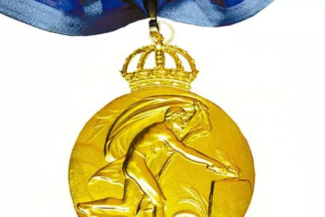 Bild av guldmedalj som hänger i ett blått snöre.
