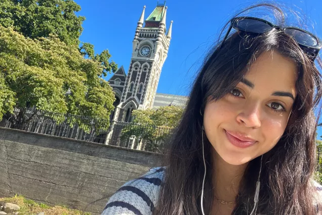 Student in front of University of Otago, New Zealand. Photo.