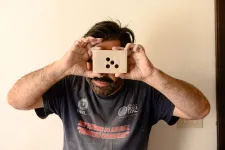 Musician with object in front of his face. Photo.