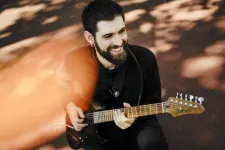 Francesco Palmieri with guitar. Photo.